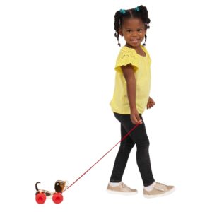 Lifestyle shot of girl pulling the Fisher-Price Little Snoopy