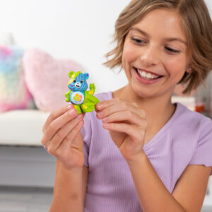 Care Bears Peel and Reveal - Lifestyle shot of smiling girl peeling bear